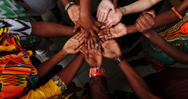 Linked hands from diverse people. Blogpost: The Power of Collaboration and Community - A Thank You From Coils to Locs.